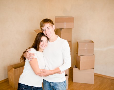Professional movers carrying furniture through a residential property in Manor House