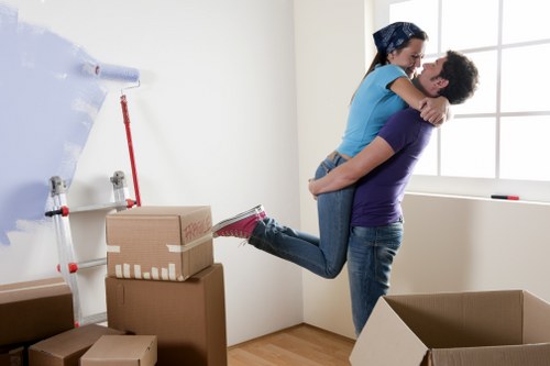 House moving crew transporting boxes and furniture between properties in Manor House