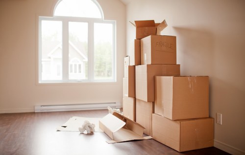 Movers carrying furniture through a residential building in Manor House