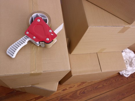 Packed moving boxes and wrapped furniture ready for local removals
