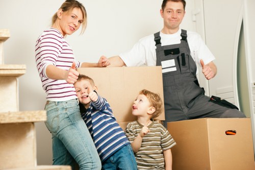 Movers carrying boxes through a flat or apartment building in Manor House